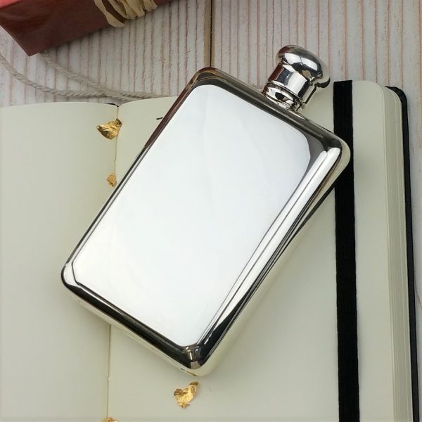 A luxury personalised sterling silver hip flask, handmade in Birmingham. Engraved to order and presented in a velvet pouch, a timeless heirloom gift.